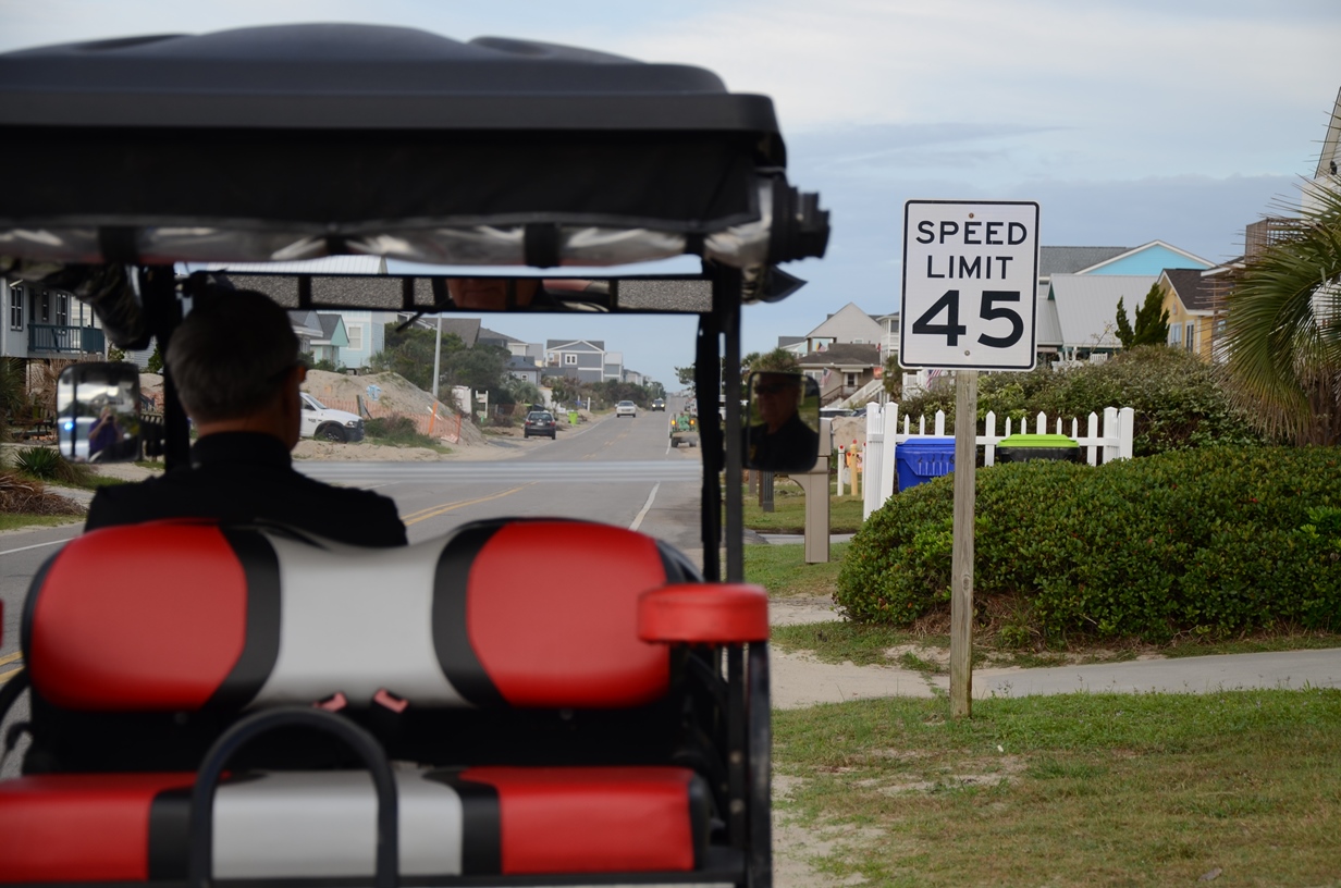 Golf Cart in front of a 45 mph speed limit sign