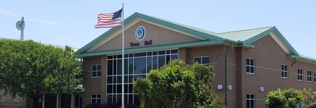 Oak Island Town Hall with flag flying in front