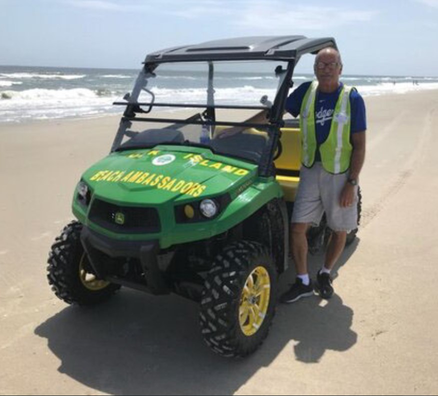 Beach Ambassador Coordinator Skip Cox in front of utility vehicle