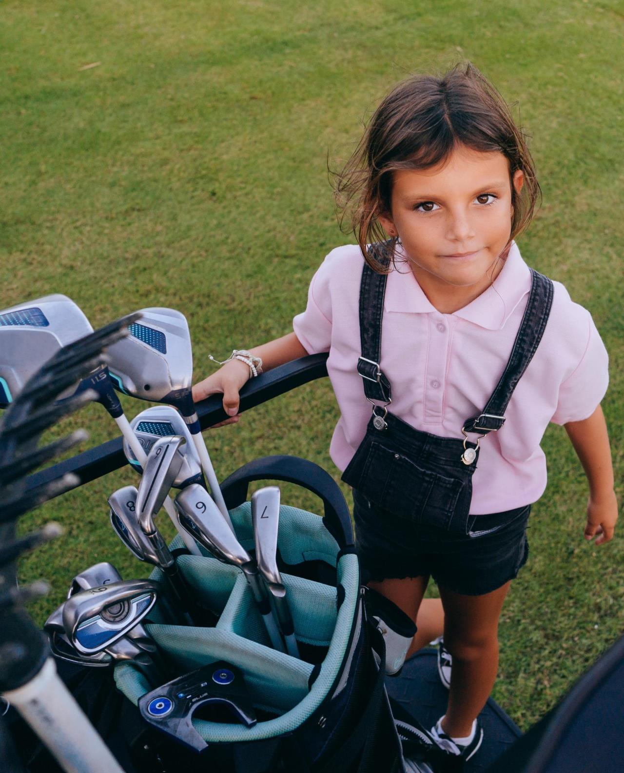 Child with Golf Clubs